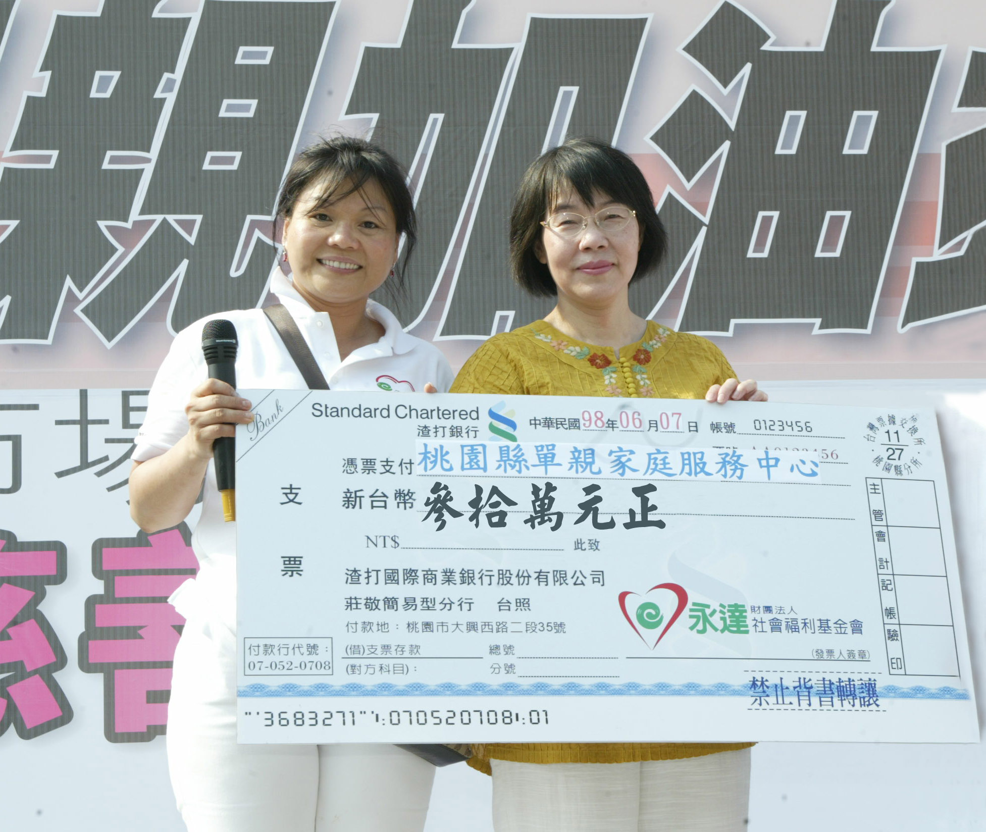 永達李秋蓮協理（圖左）代表致贈當日募得款項予「桃園縣單親家庭服務中心」陳瑪利秘書長(圖中捐款金額30萬為至活動當天下午4點暫之金額，活動結算款實際捐贈金額為515,006元。