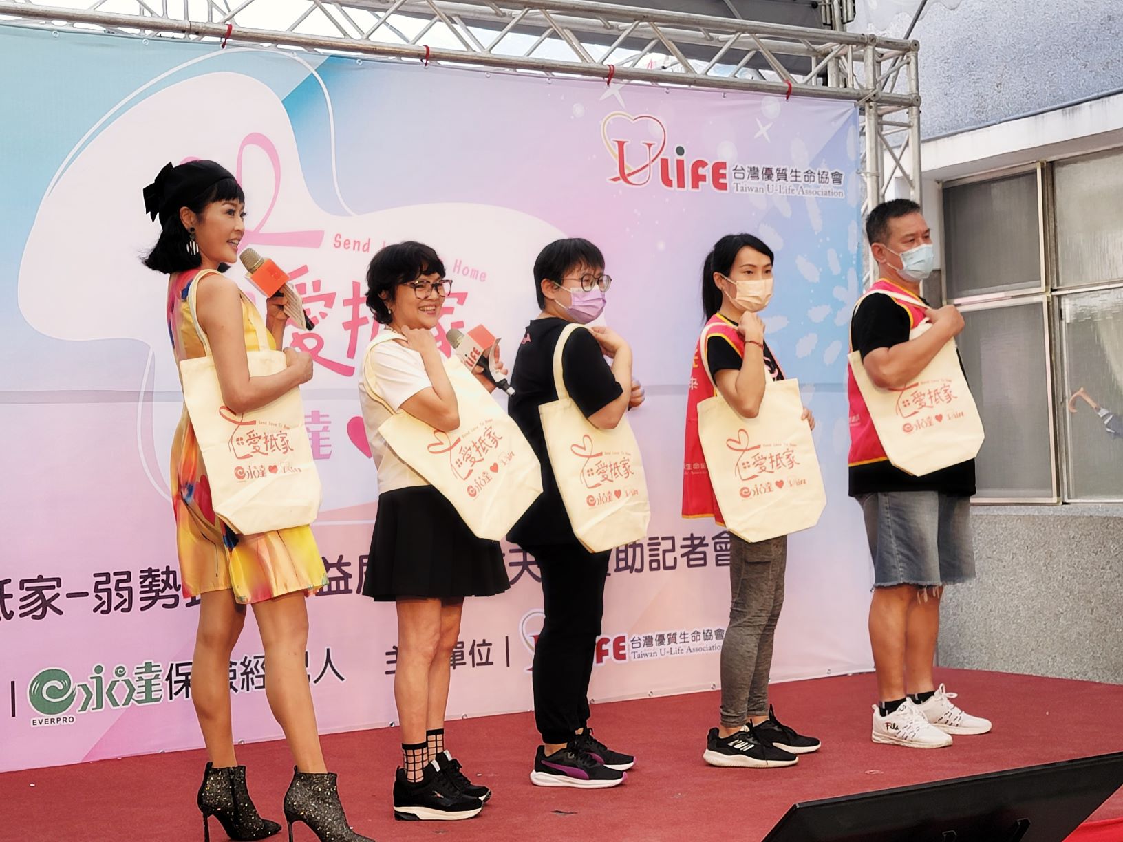 (圖左起)主持人唐林、紀寶如和居服員一同展示愛抵家聯名提袋。